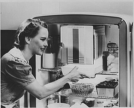 B&W Vintage image of a woman & her fridge